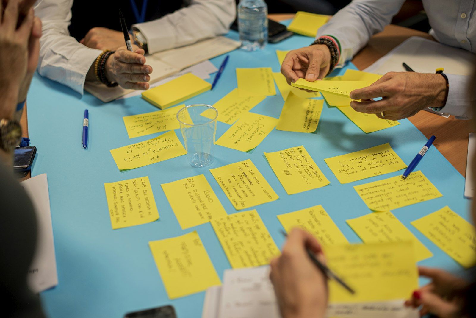 A hand holding yellow sticky notes.