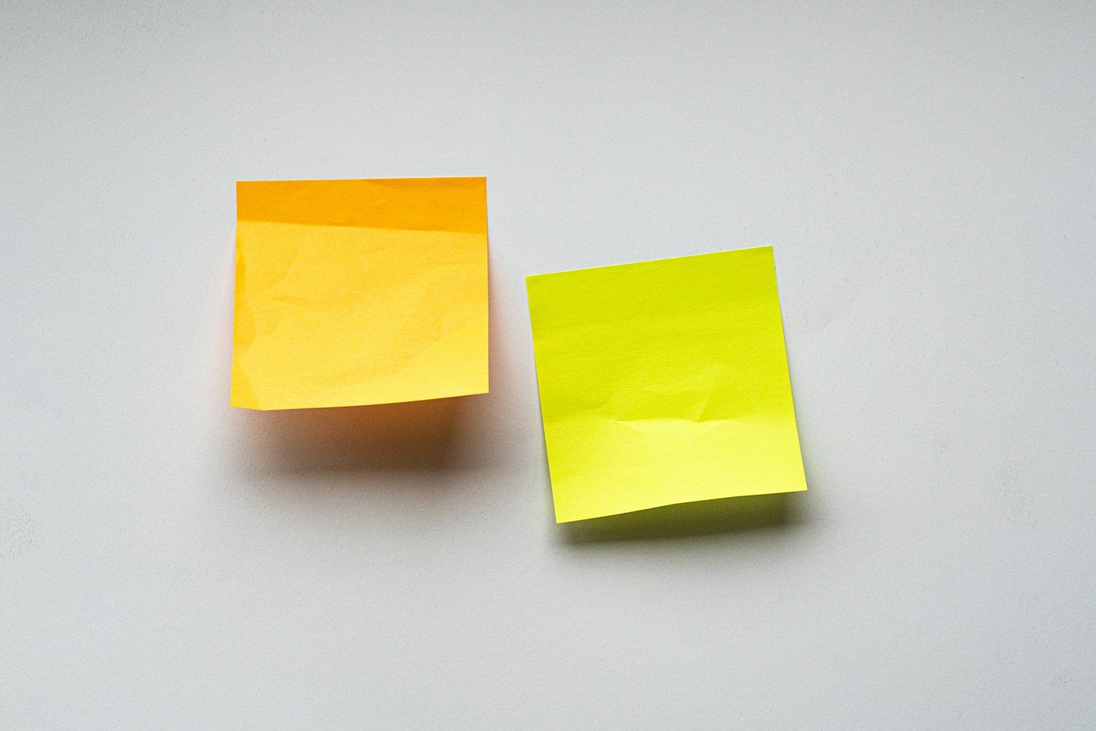 Yellow sticky notes on a white wall.